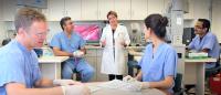 Instructor and students in the Microsurgery lab